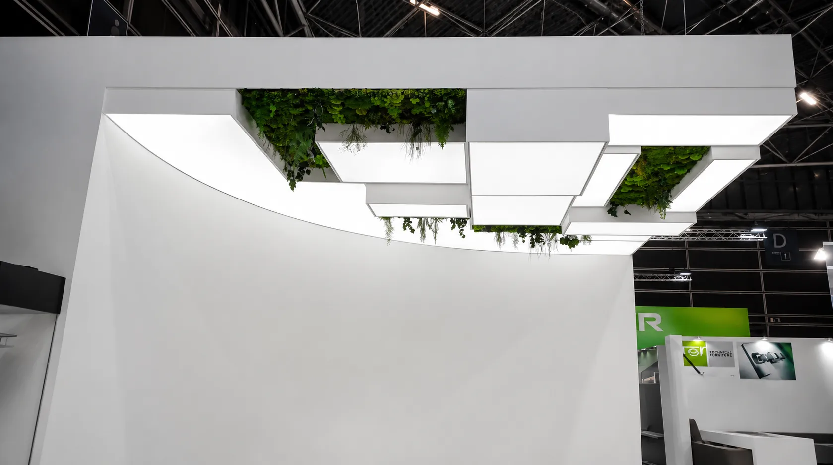 Commercial stretch ceiling with illuminated panels and integrated green wall detail
