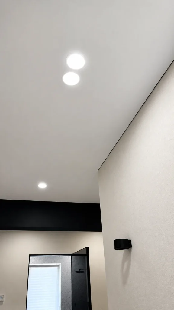 Fabric stretch ceiling with matte finish and recessed spotlights in a modern interior