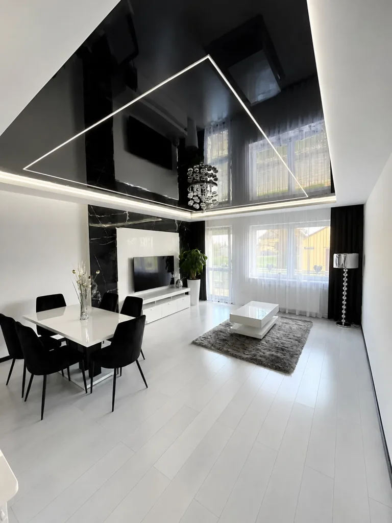 Mirror stretch ceiling in a luxury dining room with chandelier and reflective ceiling panels