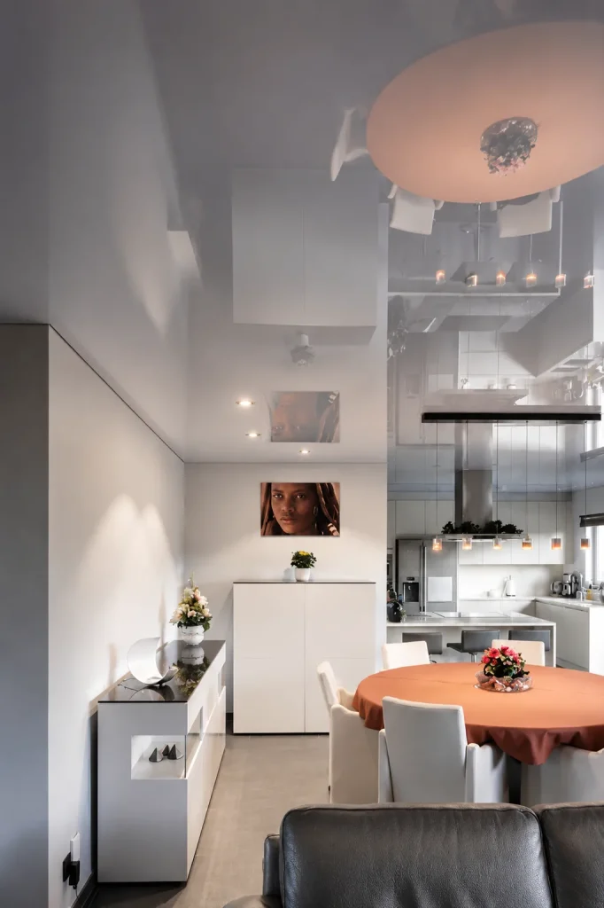 Glossy stretch ceiling in an open plan kitchen and dining area