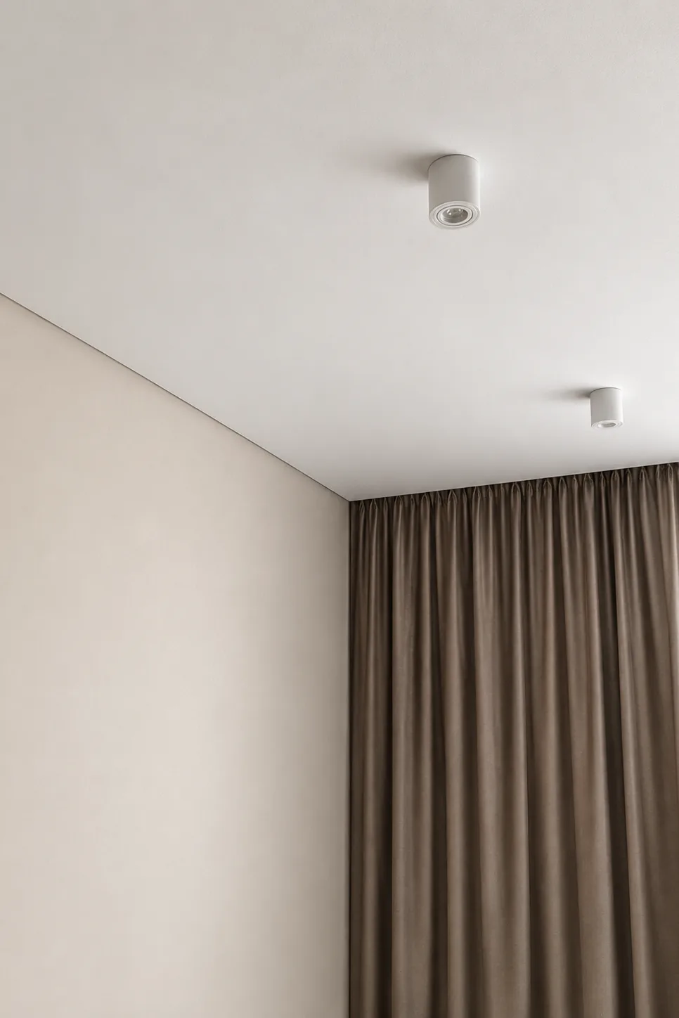 Shadow Stretch Ceilings Fabric stretch ceiling with surface-mounted spotlights in a modern room