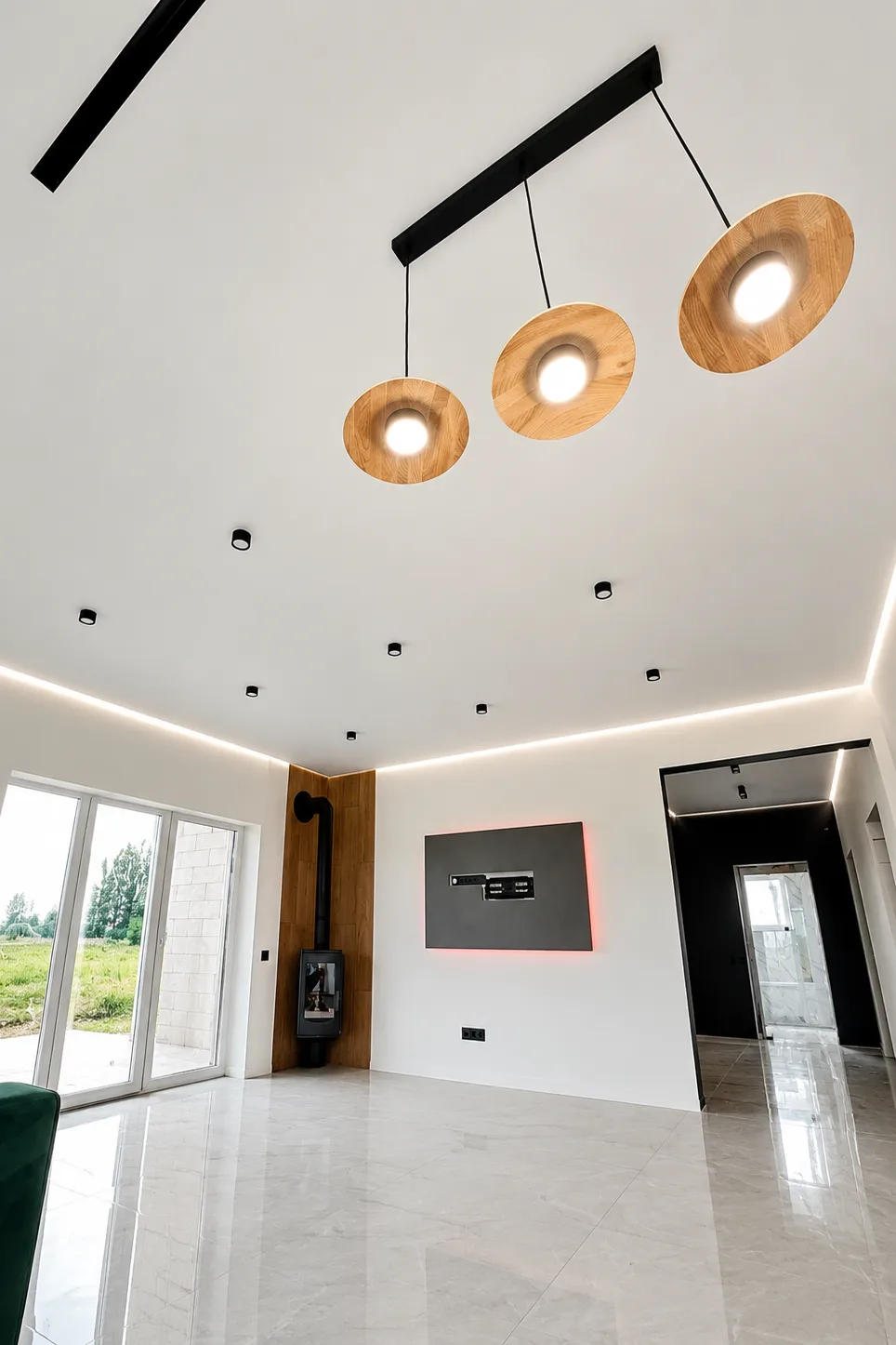 Services Glossy stretch ceiling with recessed spotlights and black track lighting in a modern room